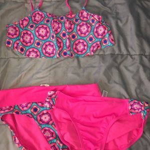 A bathing suit top with two bottoms